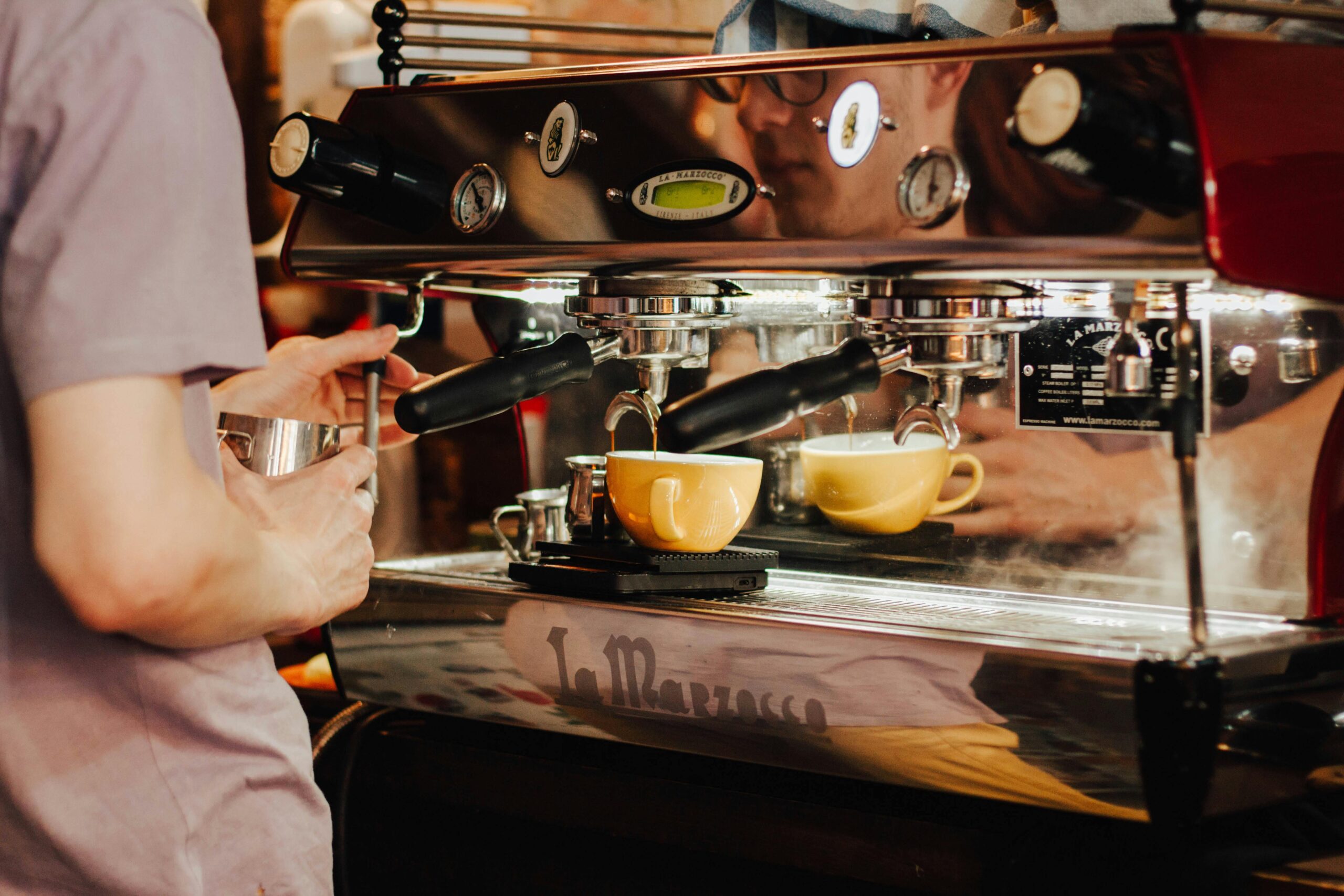 a person pouring coffee into a cup